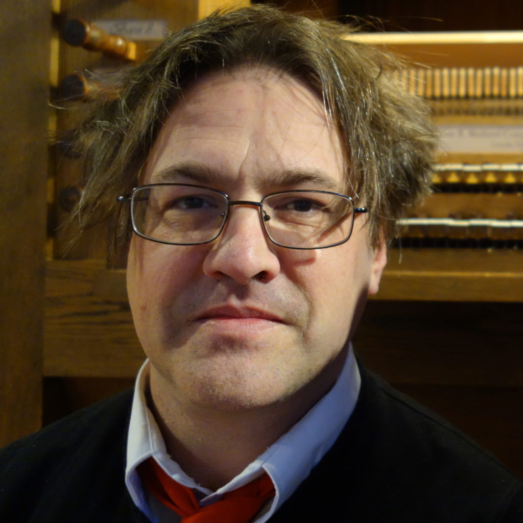 Kurt Knecht in front of an organ.
