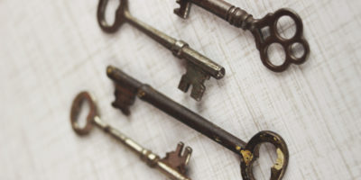 Four old fashioned metal keys.