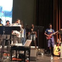 A group of performers and singers on stage