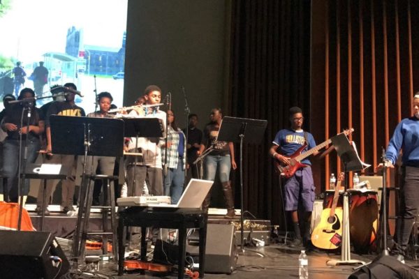 A group of performers and singers on stage