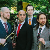 Outdoor photo of multi-instrumental ensemble