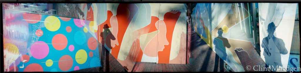 An original photograph by Clint Maedgen collaging abstract paintings and a silhouette of a man wearing a hat,