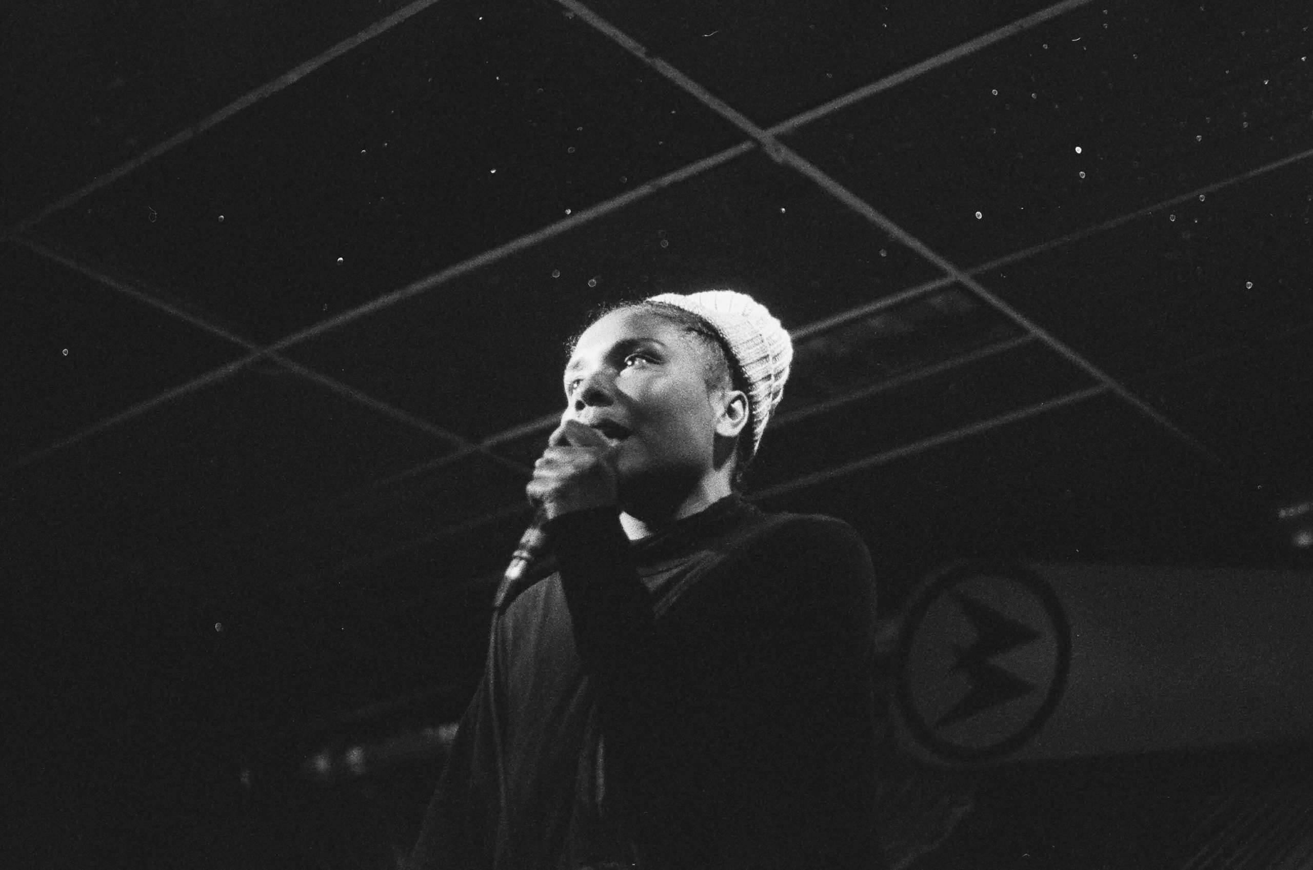 Mary Lawson a.k.a. Mesonjixx holding a microphone