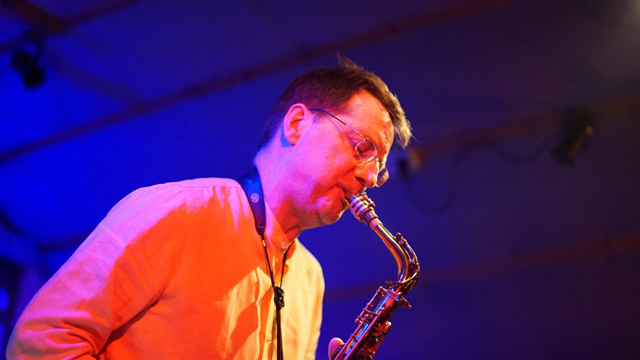 Neil Leonard playing a saxophone.