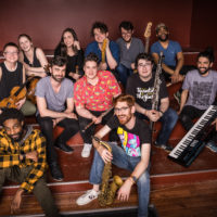 A colorful group photo of the ensemble members of ShoutHouse