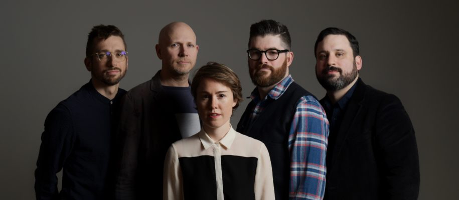 So Percussion and Caroline Shaw pose in front of a grey background