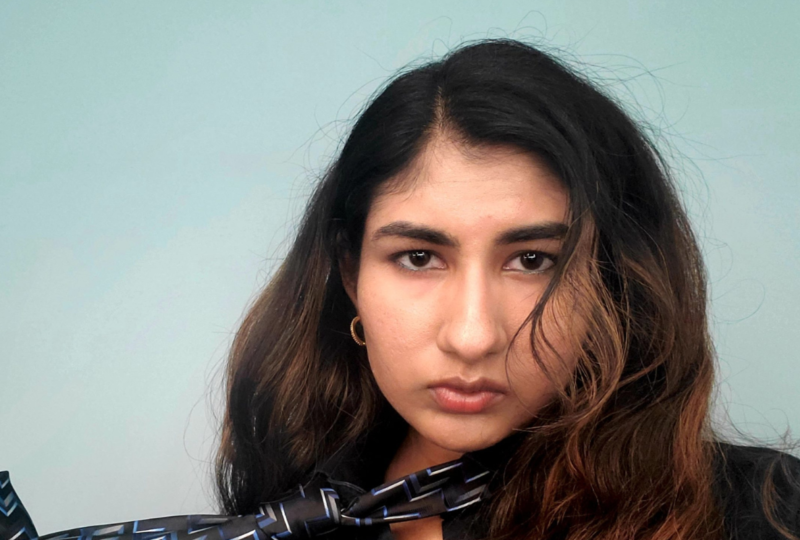 woman with brown hair on blue background